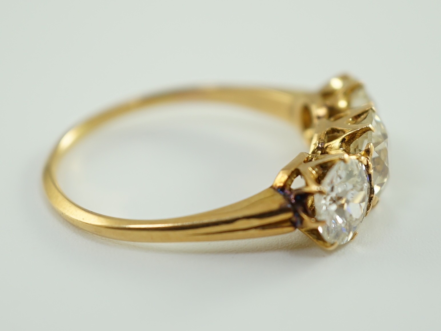 A gold and three stone diamond ring